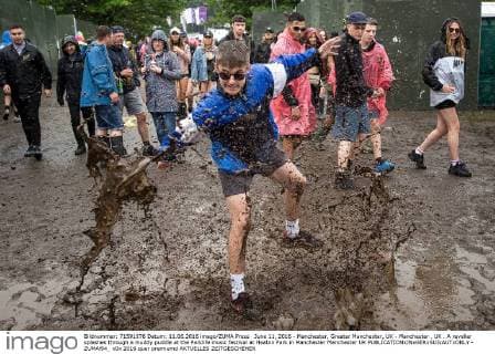 June 11, 2016 - Manchester, Greater Manchester, UK - Manchester , UK . A reveller splashes through a muddy puddle at the Parklife music festival at Heaton Park in Manchester Manchester UK  - ZUMAl94_