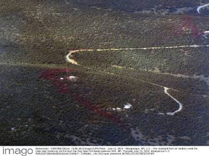 June 16, 2016 - Albuquerque, NM, U.S. - Fire retardant from air tankers mark the trees near homes as the fire from the Dog Head Fire heads towards Chilili ,NM. Thursday June 16, 2016. Albuquerque U.S. - ZUMAab1_