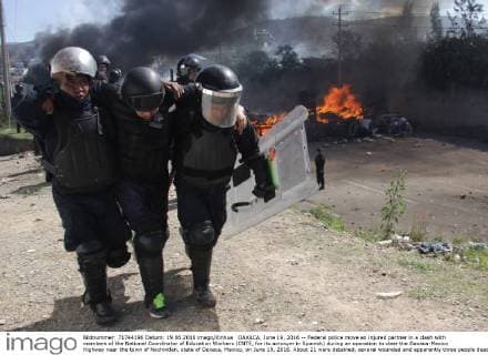 OAXACA, June 19, 2016 -- Federal police move an injured partner in a clash with members of the National Coordinator of Education Workers (CNTE, for its acronym in Spanish) during an operation to clear the Oaxaca-Mexico Highway near the town of Nochixtlan, state of Oaxaca, Mexico, on June 19, 2016. About 21 were detained, several wounded and apparently three people dead in the clash between police and members of the CNTE, according to the first official reports. ) (vf) (ah) MEXICO-OAXACA-SOCIETY-PROTEST MaxxNunez 