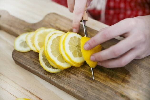 Woman s hands cutting lemon model released Symbolfoto  RTBF000204