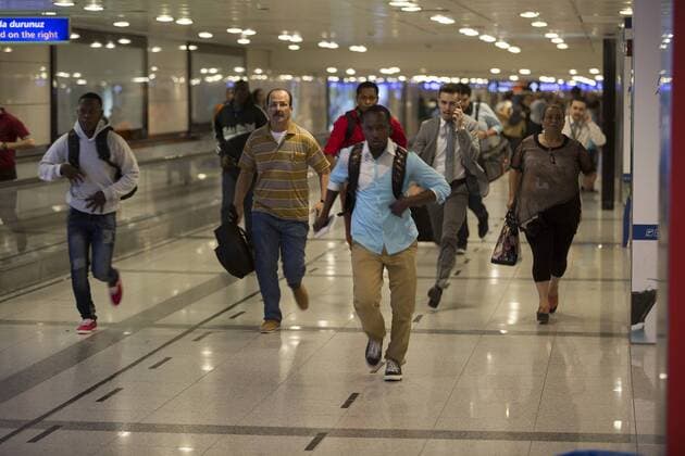 Travelers at the Ataturk Airport flee after two explosions followed by gunfire hit Turkey s biggest airport, killing dozens and injuring many on June 28, 2016, in Istanbul. All flights at Istanbul s Ataturk international airport were suspended, Turkish television stations reported.  TRK2016062903 LAURANCExCAMERON