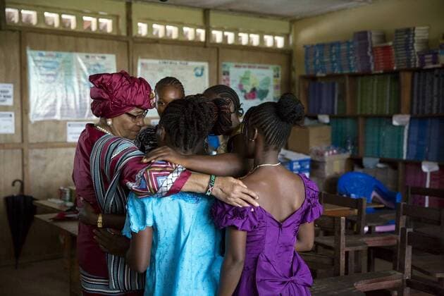 June 27, 2016 - Monrovia, Liberia - Liberian President Ellen Johnson Sirleaf hugs students prior to a Let Girls Learn roundtable discussion at R.S. Caulfield Senior High School June 27, 2016 in Unification Town, Liberia. Sirleaf joined in U.S First Lady Michelle Obama in the discussion. Monrovia Liberia - ZUMAp138