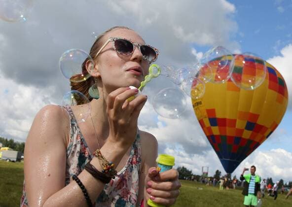 TVER REGION, RUSSIA - JULY 9, 2016: A girl blows bubbles at the 16th Nashestvie (Invasion) rock music festival in the village of Bolshoye Zavidovo. Alexander Ryumin TASS  TS02970A
