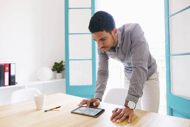 Young businessman using digital tablet in office model released Symbolfoto property released  EBSF001464