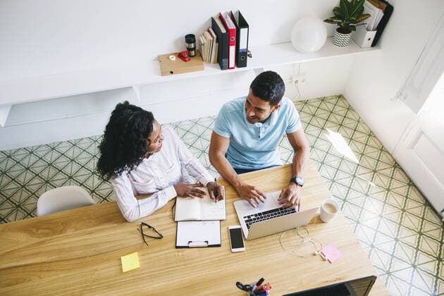 Young businessman and woman working together in office, using laptop model released Symbolfoto property released  EBSF001508