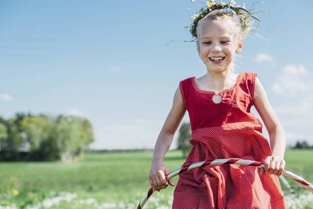 Happy girl with hula hoop wearing flower wreath model released Symbolfoto  MJF001936