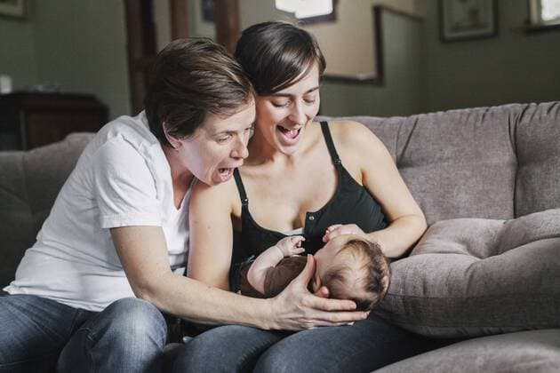 A same sex couple, two women playing with their 6 month old baby girl. A same sex couple, two women playing with their 6 month old baby girl.  22212
