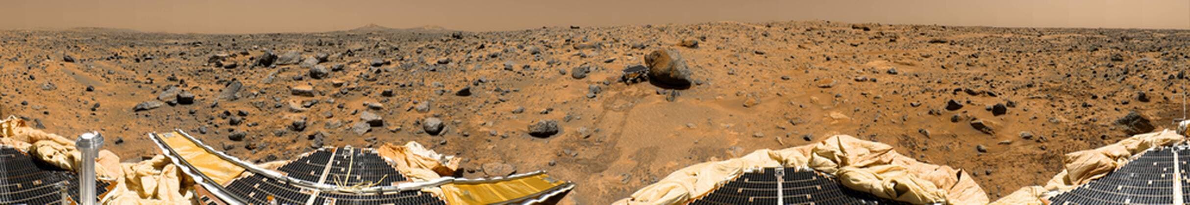 November 4, 1997 - This is a geometrically improved, color enhanced version of the 360-degree panorama heretofore known as the Gallery Pan, the first contiguous, uniform panorama taken by the Imager for Mars Pathfinder (IMP) over the course of Sols 8, 9, and 10. Different regions were imaged at different times over the three Martian days to acquire consistent lighting and shadow conditions for all areas of the panorama. At left is a Lander petal and a metallic mast which is a portion of the low-gain antenna. Misregistration in the antenna and other Lander features is due to parallax in the extreme foreground. On the horizon the double Twin Peaks are visible, about 1-2 kilometers away. The rock Couch is the dark, curved rock at right of Twin Peaks. Another Lander petal is at left-center, showing the fully deployed forward ramp at far left, and rear ramp at right, which rover Sojourner us  Copyright: StocktrekxImages stk202209s