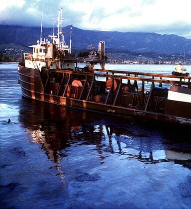May 04, 2010 - California, U.S. - Oil spill & pollution---Boat in oil-covered waters in SB Harbor following spill in 1969. The Santa Barbara oil spill occurred in 1969 in the Santa Barbara Channel. The source was a January 28, 1969 blow-out on Union Oil s Platform A, six miles offshore, in the Dos Cuadras Offshore Oil Field. Over a 10-day period, an estimated 80,000 to 100,000 barrels 1 of crude oil spilled into the channel and onto the beaches of Santa Barbara County in Southern California, fouling the coastline from Goleta to the Rincon, and all four of the northern Channel Islands. Upward of 10,000 birds were killed in the ecological disaster.JOHN ZANT NEWS-PRESS FILE PHOTO - ZUMAb77_