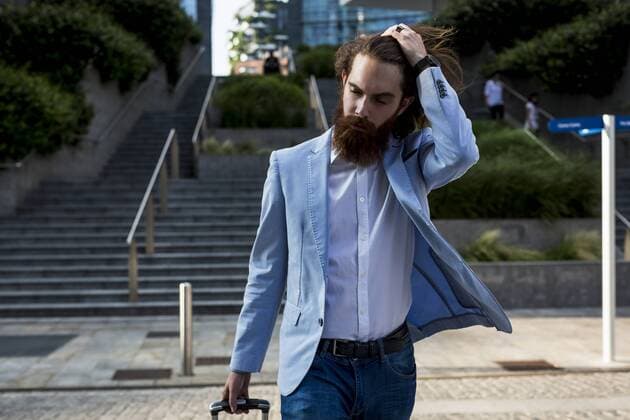 Stylish businessman walking with suitcase on stairs outdoors model released Symbolfoto  MAUF000779