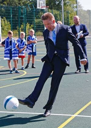 Kaliningrad: Alexei Miller weiht FuÃŸballplatz ein KALININGRAD REGION, RUSSIA - AUGUST 26, 2016: Chairman of the board at Gazprom Alexei Miller (front) kicks the ball during a ceremony at a new sportsground built by Gazprom for a local school in the town of Chernyakhovsk. Vitaly Nevar TASS  TS02ECB9