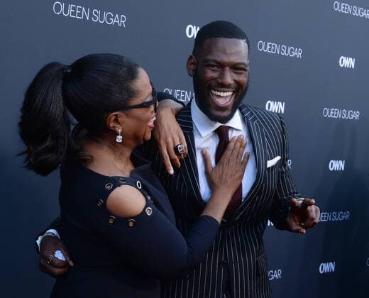 Executive producer Oprah Winfrey (L) and cast member Kofi Siriboe attend the premiere of OWN s television drama series Queen Sugar at Warner Bros. Studio in Burbank, California on August 29, 2016. Storyline: The series chronicles the lives and loves of three estranged siblings in Louisiana.  LAP2016082933 JIMxRUYMEN