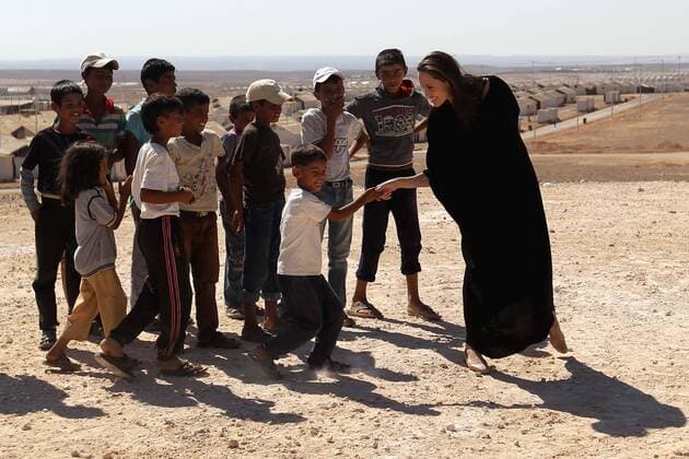(160909) -- AZRAQ, Sept. 9, 2016 -- U.S. actress and special envoy to the United Nations High Commissioner for Refugees(UNHCR) Angelina Jolie(1st R) talks to children during a visit to a Syrian refugee camp in Azraq, Jordan, on Sept. 9, 2016. ) JORDAN-AZRAQ-SYRIAN REFUGEE CAMP-VISIT MohammadxAbuxGhosh 
