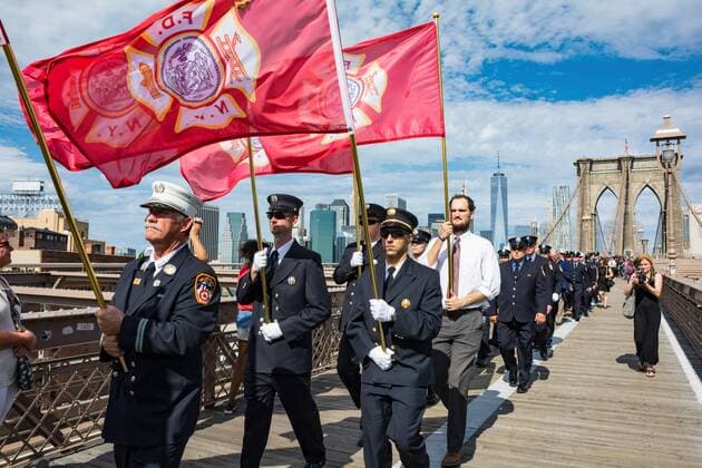 USA: September 11 Memorial and Mozart Requiem Firefighters from across the country joined New York City s bravest and families of the fallen at ground zero in lower Manhattan. From there, the group of Firefighters marched 24 flags in single file across the Brooklyn Bridge. Each flag represented one of the 24 Firefighters from Battalion 57 in Brooklyn killed in the line of duty at the World Trade Center on September 11, 2001. Their bodies were never recovered. The journey from ground zero to Brooklyn symbolized the return to the fallen heroes back home. The procession also included a FDNY ceremonial flag for every firefighter killed on 9 11 and an American flag, in remembrance of all who died in the September 11th terror attacks 15 years ago. Led by firetrucks and motorcycles, the procession marched and visited several firehouses and continued to the Co-Cathedral of St. Joseph in Prospect  CorazonxAguirre
