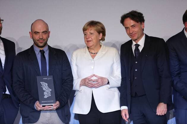 Presentation of the M100 Media Prize in Potsdam The presentation of the M100 Media Prize in the Orangery Palace in Potsdam was attended by Chancellor Dr. Angela Merkel, Roberto Saviano, author ( Gomorrah ), journalist and M100 Media Award winners 2016 Giobanni di Lorenzo, editor in chief, Die Zeit and Jann Jakobs, Lord Mayor of Landeshauptstad Potsdam.  SimonexKuhlmey
