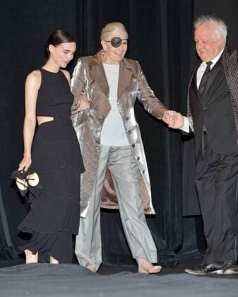 Rooney Mara (L) and Vanessa Redgrave walk out barefoot onto the stage with an assist from director Jim Sheridan (R) for the cast introductions at the Toronto International Film Festival premiere of The Secret Scripture at Roy Thomson Hall in Toronto, Canada on September 15, 2016.  TOR2016091517 CHRISTINExCHEW