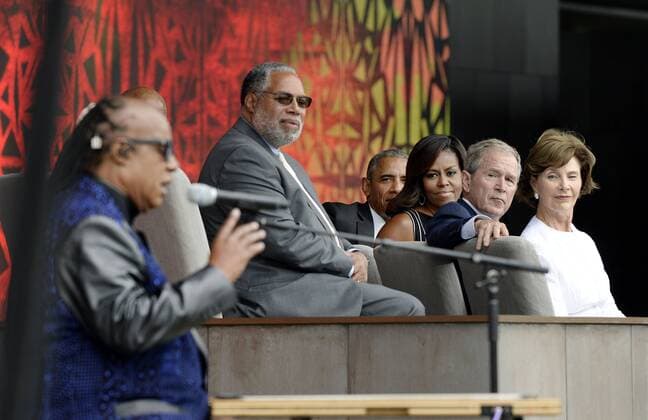 September 24, 2016 - Washington, District of Columbia, United States of America - (R to L) : Former First Lady Laura Bush, former President George W. Bush, U.S President Barack Obama and First Lady Michelle Obama listen to singer Stevie Wonder during the opening ceremony of the Smithsonian National Museum of African American History and Culture on September 24, 2016 in Washington, DC. The museum is opening thirteen years after Congress and President George W. Bush authorized its construction. .Credit: Pool via CNP Washington United States of America - ZUMAs152