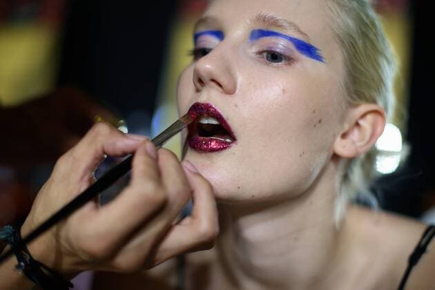 MILAN, Sept. 24, 2016 -- A model has her make-up applied backstage before the Leitmotiv show as part of Milan Fashion Week Spring Summer 2017 in Milan, Italy, on Sept. 24, 2016. )(axy) ITALY-MILAN-FASHION WEEK-LEITMOTIV JinxYu 