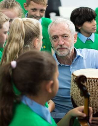 September 27, 2016 - Liverpool, Merseyside, UK - Liverpool , UK . Labour Party leader JEREMY CORBYN with a bongo drum during a visit to Faith Primary School in Liverpool , where he listens to and then joins in with the school orchestra Liverpool UK  - ZUMAl94_