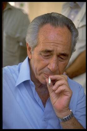 A file handout photo dated, August 12, 1986, provided by the Israeli Government Press Office, shows Israeli leader Shimon Peres smoking a cigarette in Israel. The elder statesman Shimon Peres died at the age 93 on September 28, 2016, at a Tel Aviv hospital. Peres was Israel s ninth President, Defense Minister, Foreign Minister and Nobel Peace Prize Laureate and was known as a man of vision and action.  JER2016092817 GPO