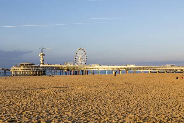 Pier in der Nordsee vor Scheveningen, Den Haag, Niederlande, mit vielen Restaurants, Geschäften, Bungee Sprungturm und Riesenrad, Strand