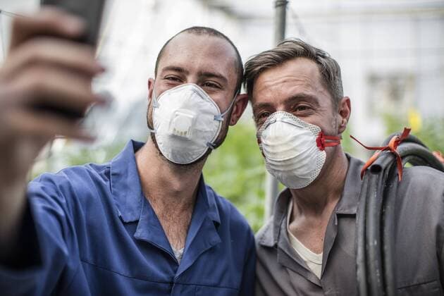 Gardeners in greenhouse taking selfie wearing face masks model released Symbolfoto property released  ZEF10436