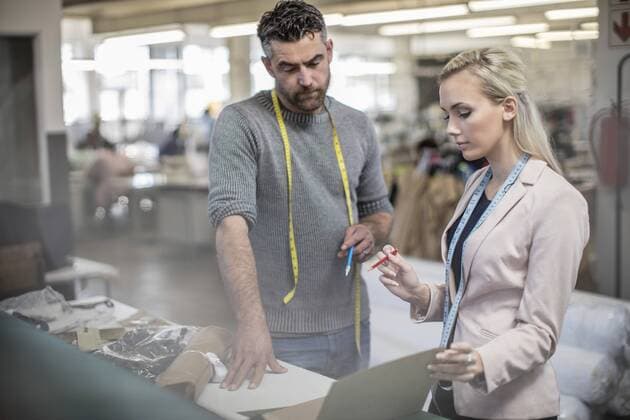 Fashion designer and tailor working together in workshop model released Symbolfoto property released  ZEF10670