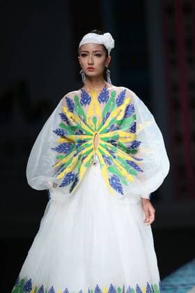 October 27, 2016 - Beijing, Beijing, China - Beijing,CHINA-October 27 2016: (EDITORIAL USE ONLY. CHINA OUT) ..A model presents a creation designed by designer Tao Tao at China Fashion Week in Beijing, October 27th, 2016.The fashion show is themed with Loulan Kingdom, which was an ancient kingdom based around an important oasis city along the Silk Road on the northeastern edge of the Lop Desert in China. Beijing China  - ZUMAs145 20161027_zaa_s145_212