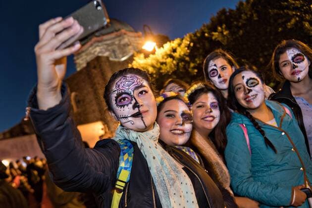 October 28, 2016 - San Miguel De Allende, Guanajuato, Mexico - Students dressed in skeleton costume take a selfie during the Day of the Dead festival in the Plaza Civica October 28, 2016 in San Miguel de Allende, Guanajuato, Mexico. The week-long celebration is a time when Mexicans welcome the dead back to earth for a visit and celebrate life. San Miguel De Allende Mexico - ZUMAe02_ 20161028_zaf_e02_020