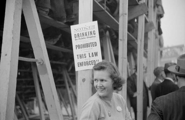 July 11, 2016 - Woman Standing Near No Drinking Sign Posted at Duke University-North Carolina Football Game, Durham, North Carolina, USA, Marion Post Wolcott for Farm Security Administration, November 1939 - ZUMAg145 20160711_zza_g145_070