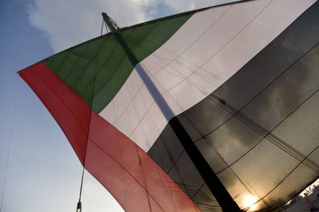 UAE, Dubai. Dhow sail from flag, backlit by sun, raised during National Day celebrations. Credit as: Bill Young Jaynes Gallery DanitaDelimont.com  Copyright: xBillxJaynesx(BJA)x xDanitaxDelimont AS44 BJA0277