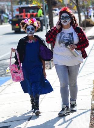 November 6, 2016 - Albuquerque, NEW MEXICO, U.S. - 110616.11 year-old Floritta Stewart,<cq>, left and her mother Simona Muniz,<cq., make their way to the start of the Dia de los Muertos Marigold Parade .Photographed on Sunday November 6, 2016. . JOURNAL. Albuquerque U.S. - ZUMAab1_ 20161106_zaf_ab1_034