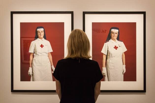 Taylor Wessing Photographic Portrait Prize 2016, National Portrait Gallery, London, UK London, UK. 16 November 2016. A NPG employee poses in front of the portraits Maria Grazia and Rosanna by Fabio Boni. Press preview of the Taylor Wessing Photographic Portrait Prize 2016 at the National Portrait Gallery. The exhibition of the winning entries and shortlisted portraits runs from 17 November 2016 to 26 February 2017.