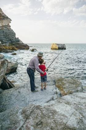 Grandfather and grandson fishing together at the sea model released Symbolfoto  DAPF00432