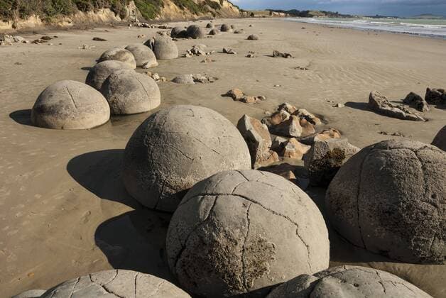 Septarian nodules washed out from cliff of Palaeocene clays, Moeraki Boulders, Dunedin, South Island, New Zealand, Pacific Copyright: TonyxWaltham 29-5374
