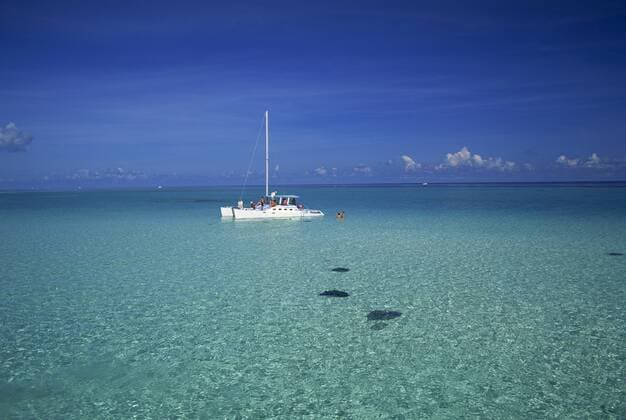 Yacht moored in the North Sound, with stringrays visible beneath the water, Cayman Islands, Caribbean, Central America Copyright: RuthxTomlinson 390-641