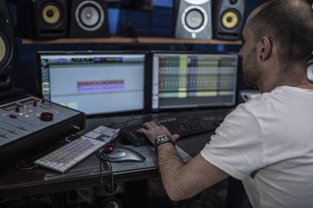 Audio engineer working in recording studio model released Symbolfoto property released  ZEF10762