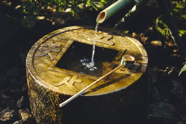 A Tsubakai, a stone wash basin for the tea room, Ryoan-ji Temple in NW Kyoto, Honshu, Japan Local Caption The Zen inscription reads I learn only to be contented Copyright: RobertxFrancis 83-5418
