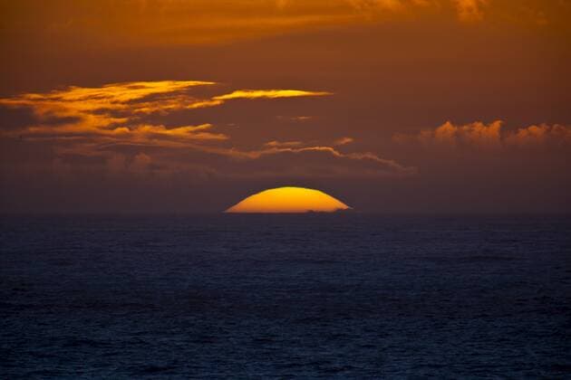 Sun setting in the west over the ocean at Woolacombe, North Devon, UK Copyright: TimxGraham 1161-4158