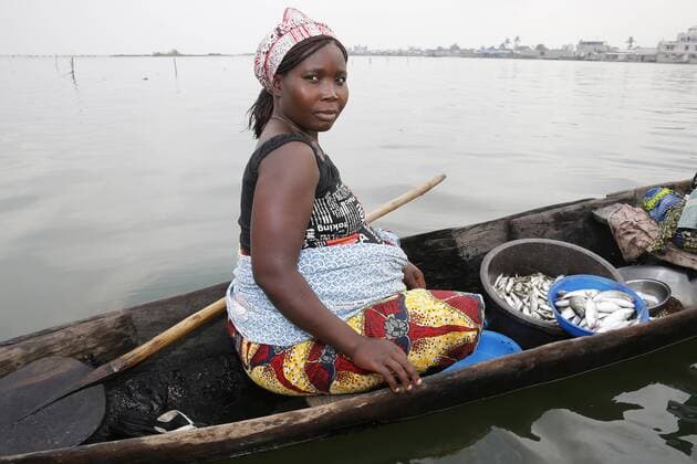 Fish seller on boat, Ayimlonfide-Ladji, Cotonou, Benin, West Africa, Africa Copyright: Godong Editorial Use Only 809-6266
