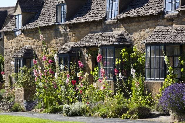 Hollyhocks and Cotswold cottage, Broadway, Worcestershire, Cotswolds, England, United Kingdom, Europe Copyright: StuartxBlack 846-1417