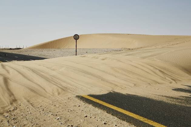 Sand dune blocks road in the Qatari desert, Qatar, Middle East Copyright: MattxFrost 975-245