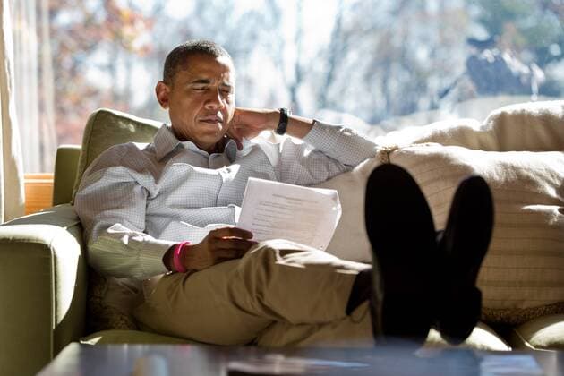 Oct. 21, 2012 - Camp David, Maryland, USA - US President Barack Obama reads briefing material while meeting with advisors October 21, 2012 inside his cabin at Camp David. Camp David USA - ZUMAz03_ 20121021_shm_z03_182