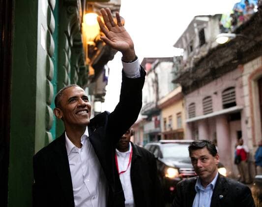 March 20, 2016 - Havana, Cuba - U.S President Barack Obama waves to people gathered to catch a glimpse as he enters a restaurant March 20, 2016 in Havana, Cuba. Barack Hussein Obama II (born August 4, 1961) is the 44th President of the United States. He is the first African American to be elected to office and the first president born outside the contiguous United States. Born in Honolulu, Hawaii, Obama is a graduate of Columbia University and Harvard Law School. He worked as a civil rights attorney and taught constitutional law at the University of Chicago Law School from 1992 to 2004. While serving three terms representing the 13th District in the Illinois Senate from 1997 to 2004, he ran unsuccessfully in the Democratic primary for the United States House of Representatives in 2000. Havana Cuba - ZUMAz03_ 20160320_shh_z03_827