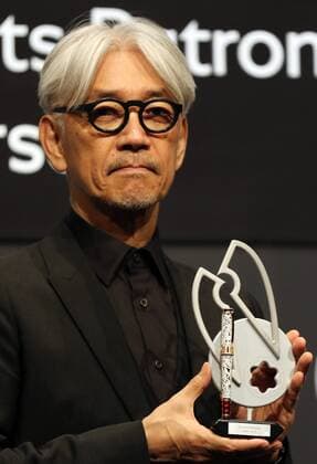 December 21, 2016, Tokyo, Japan - Japanese composer Ryuichi Sakamoto, a member of the Yellow Magic Orchestra (YMO) displays a special fountain pen after he received Montblanc de la Culture Arts Patronage Award in Tokyo on Wednesday, December 21, 2016. Sakamoto played his screen music Merry Christmas Mr. Lawrence with young musicians.  (lwxa006997)
