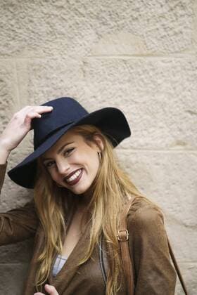 Portrait of smiling woman wearing leather jacket and blue hat model released Symbolfoto  KKAF00241