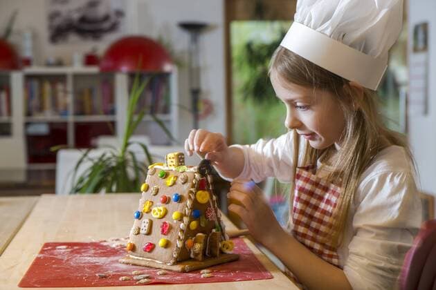 Girl garnishing gingerbread house model released Symbolfoto property released  SARF03091