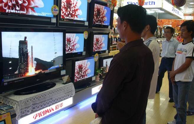Oct 24, 2007 - Nanning, Guangxi, China - Local residents watch a TV showing the Long March 3A rocket carrying China s first lunar orbiter, the Chang e I, blasting off from the Xichang Satellite Launch Centre, at a shopping mall in Nanning of southwest China s Guangxi Zhuang Autonomous Region. China s first moon probe, the satellite Chang e I took off at 6:05pm as scheduled in the center in southwestern Sichuan Province, a major step in the country s plans to eventually land a spacecraft on the moon. The orbiter is expected to relay the first picture of the moon in late November and will also carry out a series of projects including acquiring 3-D images and analyzing the distribution of elements on the moon s surface during a year-long lunar exploration.  - ZUMAc32_ 20071024_jab_c32_758