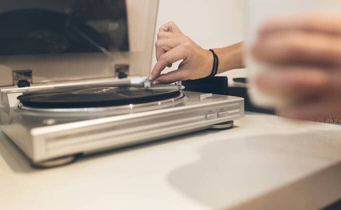 Woman putting on an old vinyl record at home model released Symbolfoto property released  MGOF02676