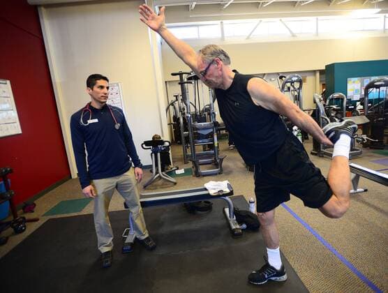 January 4, 2017 - Albuquerque, NEW MEXICO, U.S. - 010417.At left Omar Negrete,<cq>, Director of Cardiac Rehabilitation at the New Mexico Heart Institute works on yoga stretches with patient Dave Jacot,<cq>.Photographed on Wednesday January 4 , 2017. . JOURNAL. Albuquerque U.S. - ZUMAab1_ 20170104_zaf_ab1_002